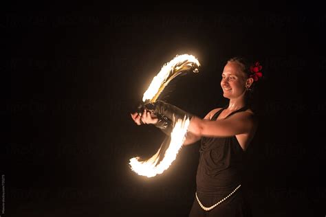 "Woman Spinning Fire" by Stocksy Contributor "Mosuno" - Stocksy