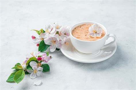 Premium Photo | Fresh morning coffee and flowers on a light wall side view copy space