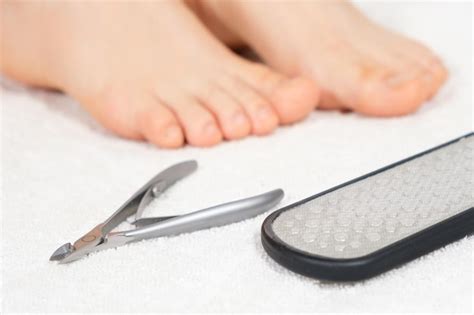 Premium Photo | Women's feet and pedicure tools