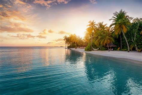 Sunrise behind a tropical island in the Maldives - RIU.com | Blog