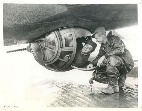 1943- U.S. 8th Air Force gunner climbs into the Sperry ball turret of a B-17 for a demonstration ...