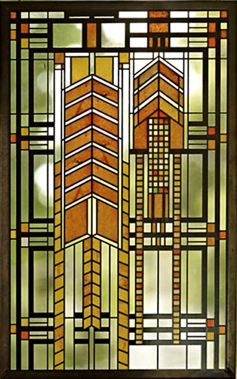 a stained glass window with an arrow design on the bottom and sides, in brown tones