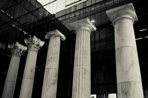 three large pillars in front of a building