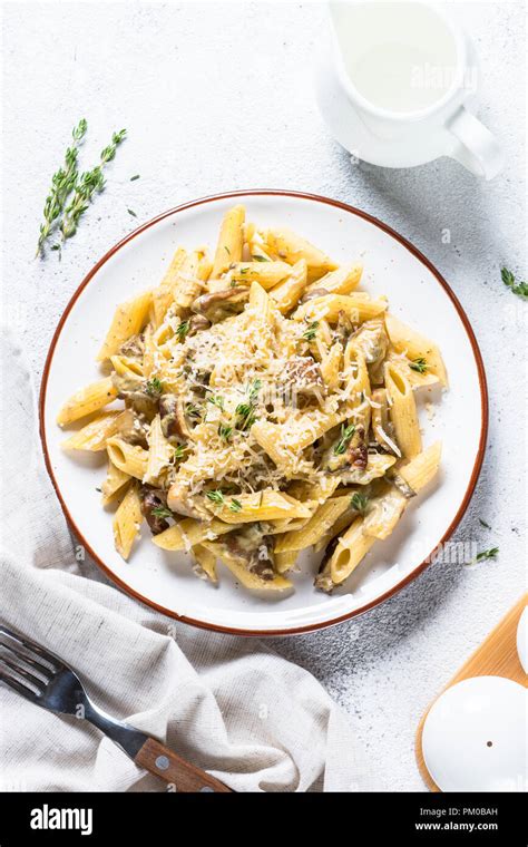 Pasta with white mushrooms in creamy sauce Stock Photo - Alamy