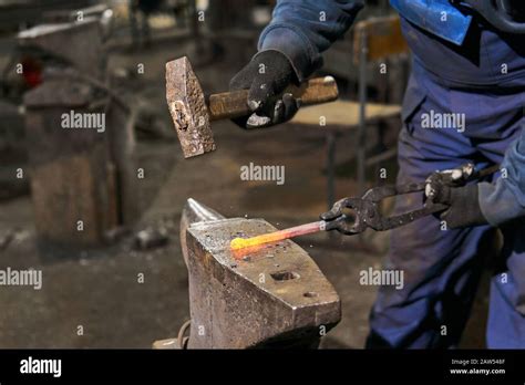 traditional forging of a hot metal billet on the anvil Stock Photo - Alamy