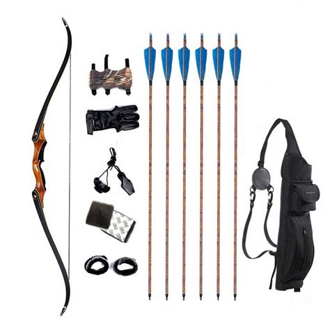 an assortment of archery equipment including bow, arrows and other items on a white background