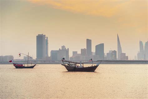 Bahrain Manama Skyline And Dhows At by Mlenny