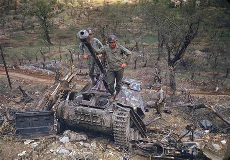 A group of American soldiers inspect heavily damaged and abandoned German armor, Italy, May 1944 ...