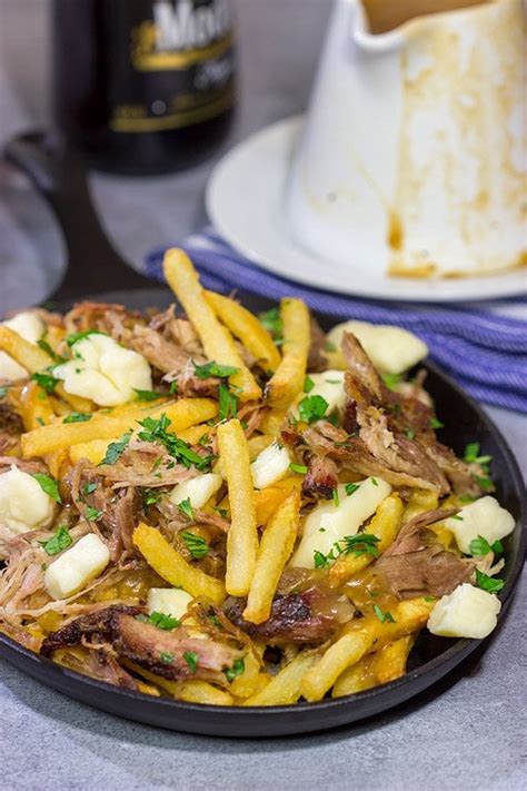 Pulled Pork Poutine | Fries topped with gravy + cheese curds + pulled pork!