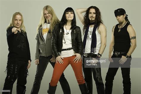 Posed studio group portrait of Finnish metal band Nightwish. Left to right are Emppu Vuorinen ...