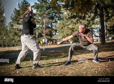 Escrima and kapap instructor demonstrates sticks fighting techniques and training methods in ...