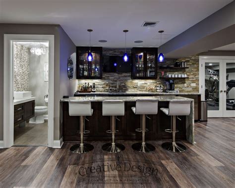 Basement - bar - bar stools - mini kitchen - cabinetry - neutral palette - lighted cabinetry ...