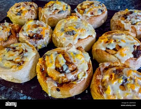 Chelsea buns with orange zest icing Stock Photo - Alamy