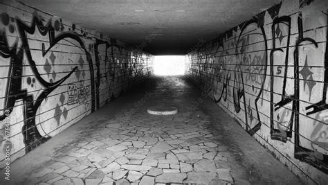 Dark underground pedestrian crossing tunnel with graffiti Stock Photo | Adobe Stock