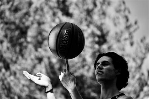 Grayscale Photo of Man Spinning a Basketball · Free Stock Photo