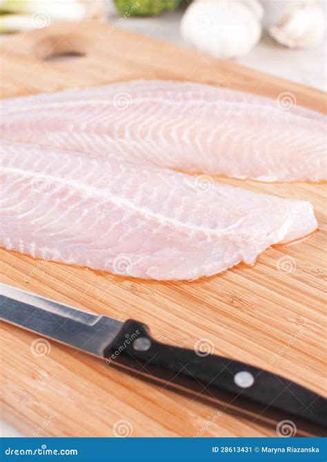 Cooking white fish fillet stock image. Image of board - 28613431