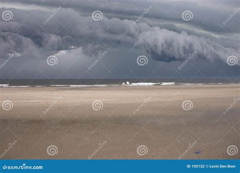 Storm clouds over beach stock photo. Image of deserted - 192152