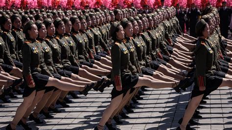 North Korea hosts military parade free of advanced missiles, focused on the economy