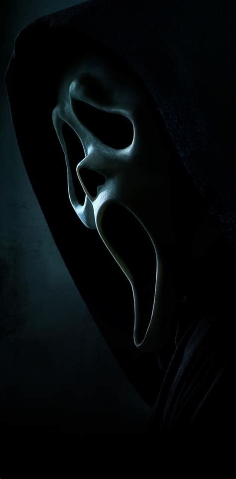 a person wearing a mask in the dark, with their face partially obscured by it