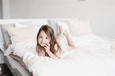 "Charming Little Girl Lying On Bed" by Stocksy Contributor "Alina Hvostikova" - Stocksy