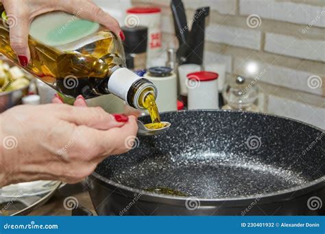 Cook Pours Oil into Frying Pan for Sauteing Vegetables on the Gas Stove Stock Photo - Image of ...