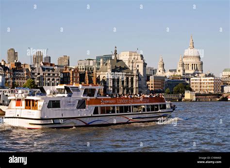 London River Thames cruise boat with St Pauls in the background at dusk ...