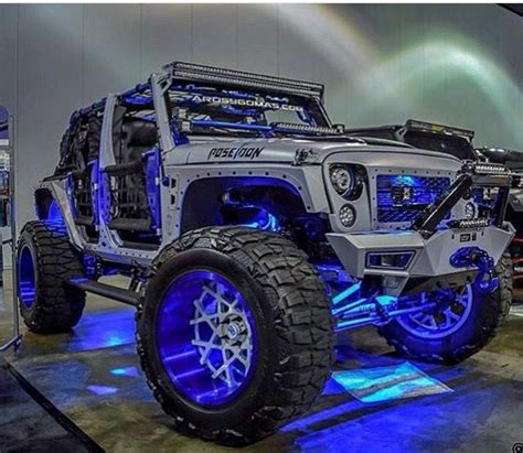 THIS SILVER JEEP JK IS DECKED OUT IN BLUE LIGHTS AND BLUE RIMS NOT TO ...