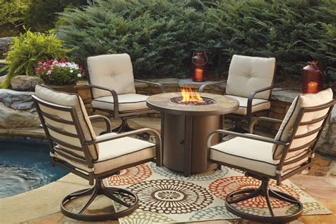 Predmore Beige and Brown Round Fire Pit Outdoor Dining Set from Ashley | Coleman Furniture