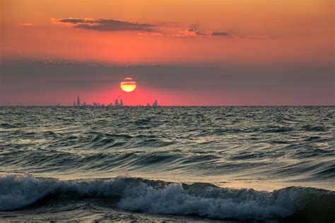 Sunset over Lake Michigan August 7. the silhouette of Chicago inside ...