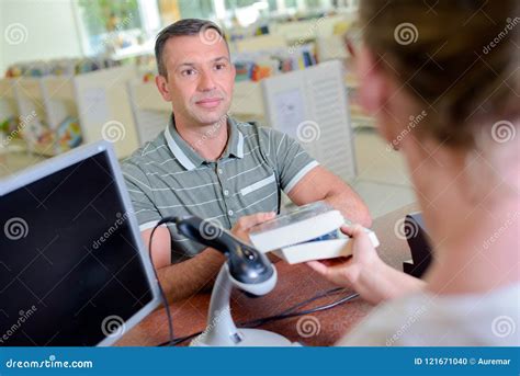 Man Borrowing Books from Library Stock Photo - Image of recreation, study: 121671040