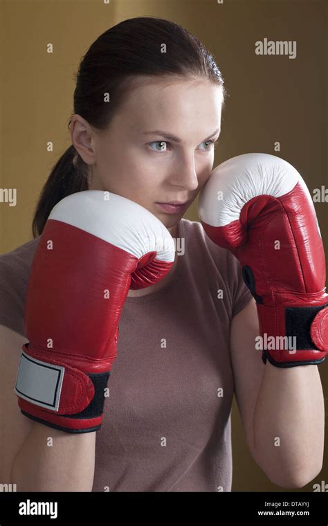 Young woman in boxing glove, looking away Stock Photo - Alamy