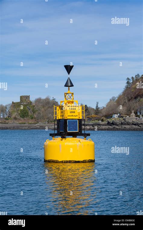 Corran Ledge buoy, west cardinal marker with Dunollie Castle Stock Photo - Alamy