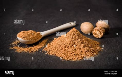 Nutmeg spice powder. Spoon and handful of chopped nutmeg. Nuts. Spices for recipes. Ground spice ...