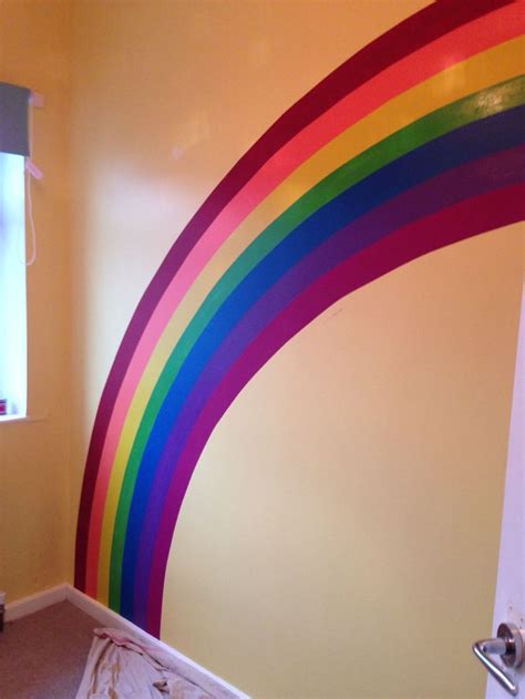 Rainbow painted on wall for nursery. Used paint tester pots and lots of 'frog tape' masking tape ...