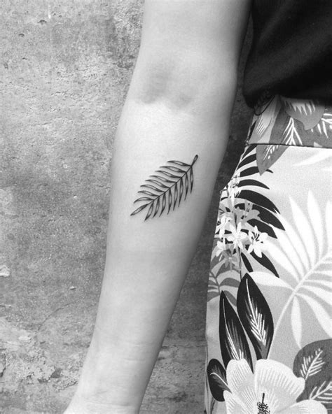 Minimalist fern leaf tattoo on the forearm - Tattoogrid.net