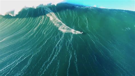 Drone video of surfer riding giant wave in Nazaré, Portugal - DroneDJ