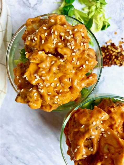 two bowls filled with food sitting on top of a table