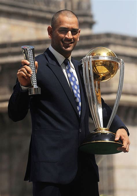 MS Dhoni with the World Cup trophy and his Man of the Match award from the final | ESPNcricinfo.com