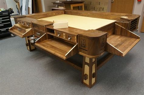 a large wooden table with drawers on each side in a room filled with ...