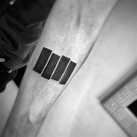 a black and white photo of a man's arm with the letter m on it