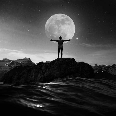 a man standing on top of a rock with his arms outstretched in front of ...