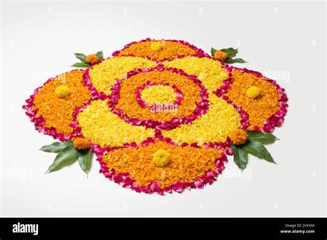 flower rangoli for Diwali or pongal made using marigold or zendu ...