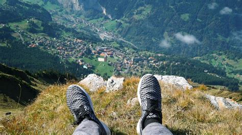 Person On A Cliff Overlooking The Mountains · Free Stock Video