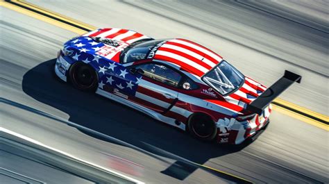 American flag racing car, patriotic car design, race track speed blur, high-speed racing, Stars ...