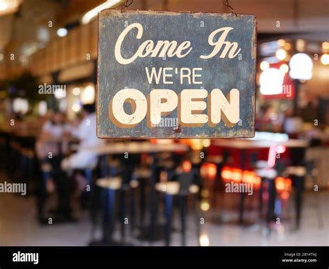 A business vintage sign that says 'Come in We're Open' on Cafe / Restaurant window. Image of ...