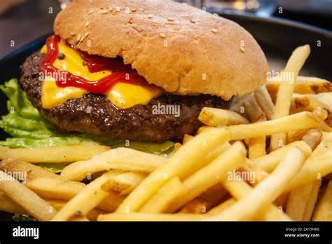 Burger, hamburger with beef, french fries, ketchup, cheese and lettuce, unhealthy food Stock ...