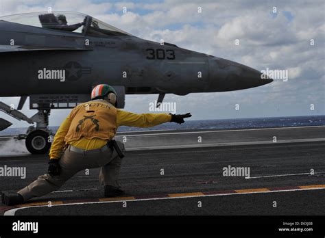 A shooter aboard the aircraft carrier USS Theodore Roosevelt (CVN 71) launches an F/A-18 Super ...