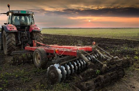 Tractor plowing a field stock photo. Image of cultivated - 61732294