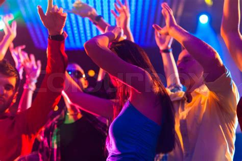 Party people dancing in disco or club | Stock image | Colourbox