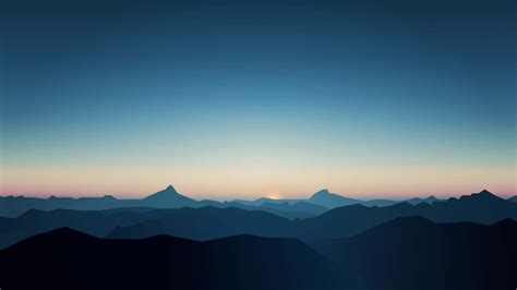 Download A Mountain Range At Sunset With Mountains In The Background ...